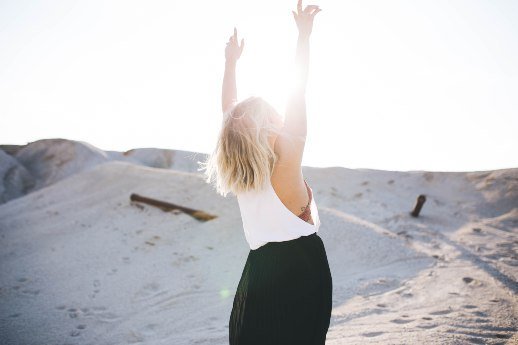 Blonde woman hands in the air